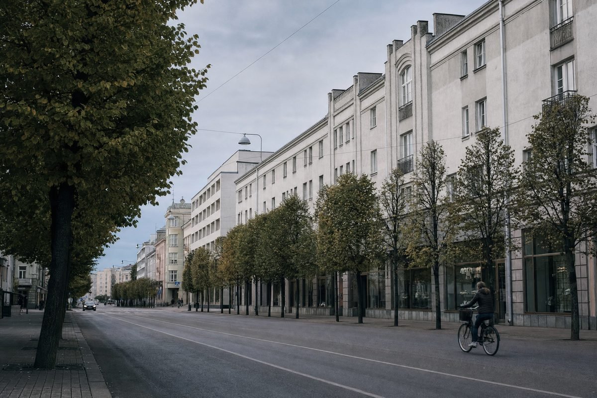 A wide boulevard lined with linden trees and 1930s modernist buildings