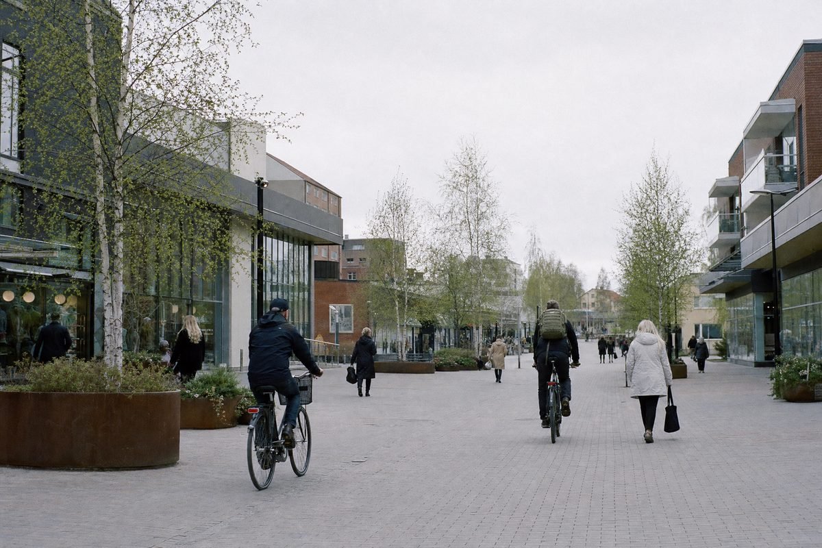 A broad pedestrian street with modern shopfronts